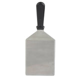 A heavy turner with a wide, rectangular stainless steel blade and a black plastic handle, shown vertically on a plain white background. This spatula is durable and dishwasher safe for easy cleaning.