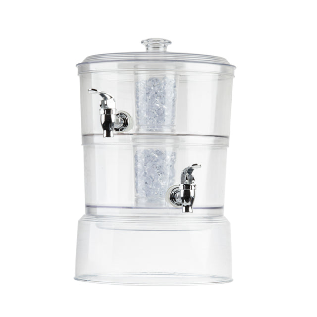 The TableCraft 2 gallon beverage dispenser is a clear plastic countertop unit with two compartments, each featuring a silver spigot. The center houses a cylindrical filter filled with white filtration media and is topped with a round lid.