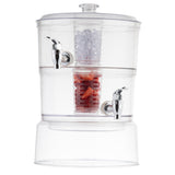 The TableCraft 2 gallon beverage dispenser features two chrome spigots. Its top chamber holds ice, the middle is filled with sliced strawberries, and the bottom is empty. The upright design includes a clear lid for easy access and stylish serving.