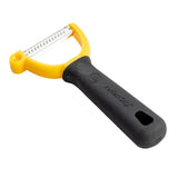 A yellow and black handheld pet grooming tool with a serrated stainless steel peeler blade and a comfortable rubberized grip handle featuring the text “Petstages Perfect Grip.” The tool is designed for removing loose fur from pets.