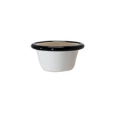 A small, white Enamelware ramekin with a rounded shape and black rim, placed against a plain white background. This 2 oz. porcelain enamel bowl has a smooth, glossy finish and appears empty.