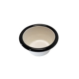 A small, 2 oz. Enamelware ramekin with a white porcelain enamel finish and rounded black rim sits on a white background. Its smooth, cream-colored interior and flared lip evoke vintage utilitarian style.