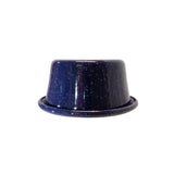 A glossy, dark blue porcelain enamel bowl with white speckles sits on a flat surface against a plain white background. The bowl has a wide base and gently tapers upward, with a slightly flared rim.