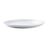 A white round plate from the Pulito Collection, with subtle concentric raised lines around the rim, is shown from a side angle on a plain white background. Its smooth, glossy surface and shallow depth make it ideal for serving food.