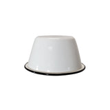 A white Enamelware bowl is turned upside down on a white background. The bowl’s smooth, glossy surface and black rim at the base stand out in this minimal image, with no other objects present.
