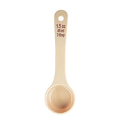 A beige polycarbonate measuring spoon viewed from above, showing measurement markings in red text: “1.5 oz, 45 ml, 3 tbsp.” The NSF-listed spoon is clean and features a circular handle hole at the top for hanging or storage.