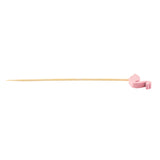 A wooden skewer, part of the TableCraft products bamboo flamingo picks collection, features a small pink flamingo-shaped decoration near one end. Laid horizontally on a white background, the decorative pick’s bird sits on the right.