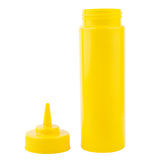 A bright yellow 12 oz mustard squeeze bottle stands upright with its pointed nozzle cap removed and lying beside it. The unlabelled, cylindrical bottle is commonly used for condiments. The background is plain white.