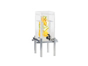A clear, rectangular beverage dispenser with a 1.5 gallon capacity and silver metal stand holds water infused with orange, lemon, and cucumber slices. The black spigot allows for easy pouring, while the infusion chamber keeps fruit slices visible inside. White background.