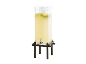 A tall, clear 3 Gallon Beverage Dispenser filled with lemonade, ice cubes, lemon slices, and mint sits on a black metal stand. It features a silver spigot near the bottom and is set against a plain white background.