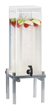 A tall, clear 3 gallon beverage dispenser on a metal stand, filled with water, strawberries, and green apple slices floating at the top. It features a central ice chamber and a black spigot at the front for pouring drinks.