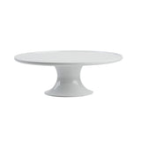 A glossy white ceramic cake stand from the Crofthouse Collection features a wide, flat round top and sturdy pedestal base. Its sleek, minimalist design gives it an elegant, modern look against the plain white background.