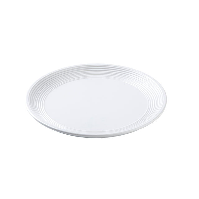 A plain white, round TableCraft Pulito Collection Plate with subtle concentric ridges near the rim, shown on a white background. The plate appears clean and empty, featuring a simple and minimalist design.