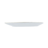 A plain, round, white TableCraft 11516 melamine serving plate is shown from a side view against a white background. The plate features a slightly raised rim and flat, smooth surface, with no visible patterns or decorations.
