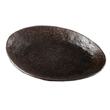 A dark, oval-shaped Lunara Collection Serving Plate with a textured, uneven surface and rim features a speckled brown and black finish. This handcrafted plate from TableCraft Products showcases a rustic, artisanal look against a plain white background.