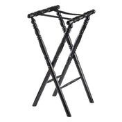 A black rubberwood folding luggage rack with a classic spindle design, featuring four turned legs, two crossed support straps on top, and decorative grooves along the legs. The rack stands open and upright on a white background.