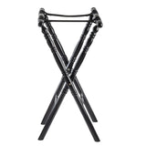 A folding luggage rack with four crossed dark rubberwood legs and two black support straps on top, designed for holding suitcases. The turned wood legs feature decorative spindle design grooves, and the rack stands upright on a white background.