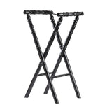 A black rubberwood folding luggage rack with spindle-turned legs and handles forms an X-shape. The rack stands upright, showing its crossed-leg spindle design and glossy finish, with four legs and two parallel top rails against a plain white background.