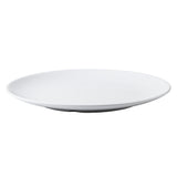 A plain, round, white ceramic plate with a smooth surface and slightly raised edges, reminiscent of the simple elegance found in the Sierra Collection Serving Platter. Photographed from a slight angle to highlight its minimalist design.