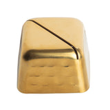A single gold-colored keycap with a backslash and vertical bar symbol ( \ | ) on top, photographed on a white background. The keycap has a shiny metallic finish reminiscent of stainless steel and a slightly rounded top edge.