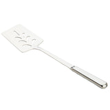 A Holden Collection Slotted Turner by TableCraft Products, this stainless steel turner features a flat, rectangular slotted blade with decorative cut-out patterns and a long handle. The angled spatula displays its reflective metallic surface against a white background.