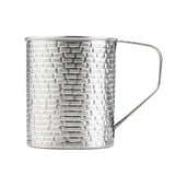 A tall, cylindrical 24 oz stainless steel mug from the Brickhouse Collection features a textured, brick-like pattern and a thin, angular handle. This TableCraft Products mug is silver, reflective, and stands upright against a plain white background.