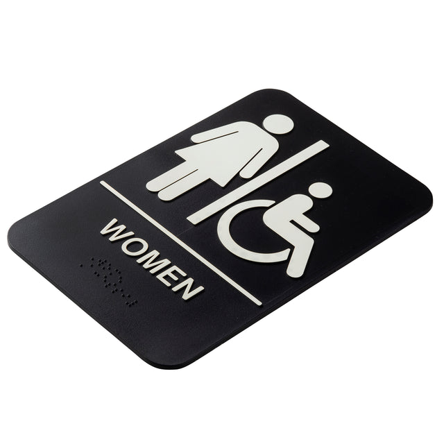 A TableCraft 11673 black polystyrene women accessible sign features white symbols of a standing woman and a person in a wheelchair, separated by a line. "WOMEN" is printed below with Braille dots, and the sign has rounded corners.