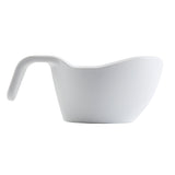 A white, modern measuring cup made of durable melamine with a built-in angled handle extending from the rim. Featuring a smooth surface and minimalist design, this dishwasher safe cup is photographed against a plain white background.