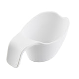 A white, ceramic scoop with a smooth, modern design sits on a plain white background. The scoop features a wide, rounded bowl and a thick, ergonomic handle, offering a minimalist look and is dishwasher safe for easy cleaning.