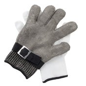 Two gloves are shown: a stainless steel cut-resistant glove with a black adjustable strap and metal buckle sits atop a plain white knit protective glove. The gloves are stacked, with the chainmail glove on top.