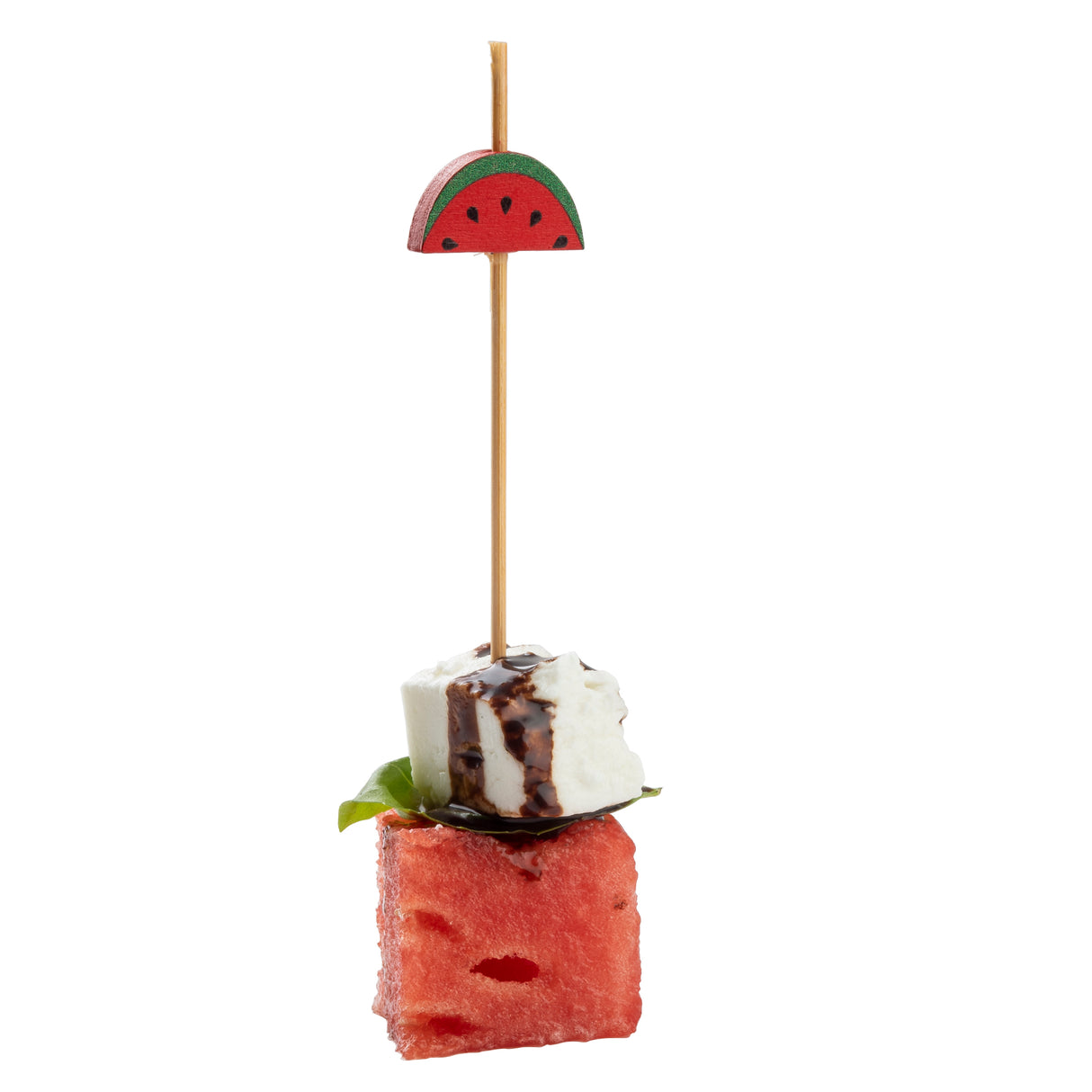 A skewer made from natural bamboo holds a watermelon slice, basil leaf, and feta cube drizzled with balsamic glaze. Topped with a decorative pick shaped like a watermelon slice, this TableCraft accessory pops against a white background.