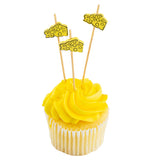 A yellow cupcake with bright yellow frosting features three Natural Bamboo Cheese Picks topped with cartoon cheese slices. The cupcake sits in a white paper liner against a white background.