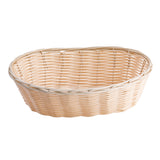 A light brown, oval-shaped wicker basket with a hand-woven pattern. The basket has short sides, no handles, and is empty, set against a plain white background.
