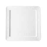 A plain, white, square ceramic plate from the Ridge Collection with slightly rounded corners and a subtle textured pattern around the rim, photographed from above on a white background. The plate’s center is smooth and unadorned.