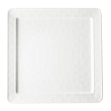 A plain white melamine square plate with a slightly raised edge and a smooth, glossy surface. The empty TableCraft serving platter sits on a white background, emphasizing its clean and simple design.
