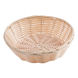 A round, shallow hand-woven basket with a tightly woven base and an open, crisscross pattern along the sides. The natural light tan color highlights the rattan texture. The empty basket is placed against a white background.