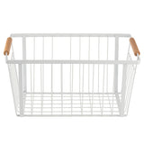 A minimalist rectangular storage basket made of powder coated steel with open sides and base, featuring two light wooden handles. The basket is empty and sits on a white background.