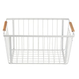 A rectangular white Storage Basket made from powder coated steel with vertical and horizontal bars, featuring two light wooden handles on opposite sides. The basket is empty and photographed against a plain white background.