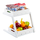A white, two-tiered snack organizer with a grab and go frame holds packaged Little Bites snacks on the top shelf and assorted fresh fruits on the bottom. The open sides, angled legs, and powder coated steel ensure both stability and modern style.
