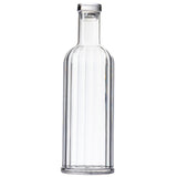 A clear, empty TableCraft glass bottle with a cylindrical shape, straight sides, and a slightly rounded shoulder. This 34 oz carafe has a narrow neck sealed with a round, flat, silver-colored cap against a plain white background.
