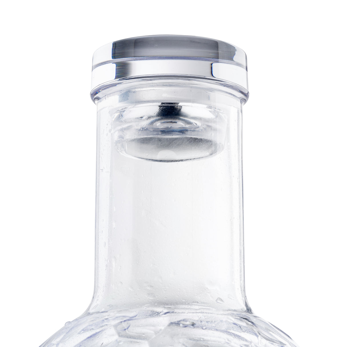 Close-up of a transparent TableCraft 34 oz carafe with a silver and clear plastic cap. The neck is covered in condensation, highlighting its cold, sleek, modern design against a plain white background.