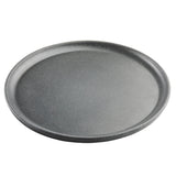 A round, gray, non-stick pizza pan from the Terra Collection is pictured on a white background. Its subtly speckled surface gives a stone-like appearance, resembling a stylish serving plate. The empty pan is viewed from a slight angle.