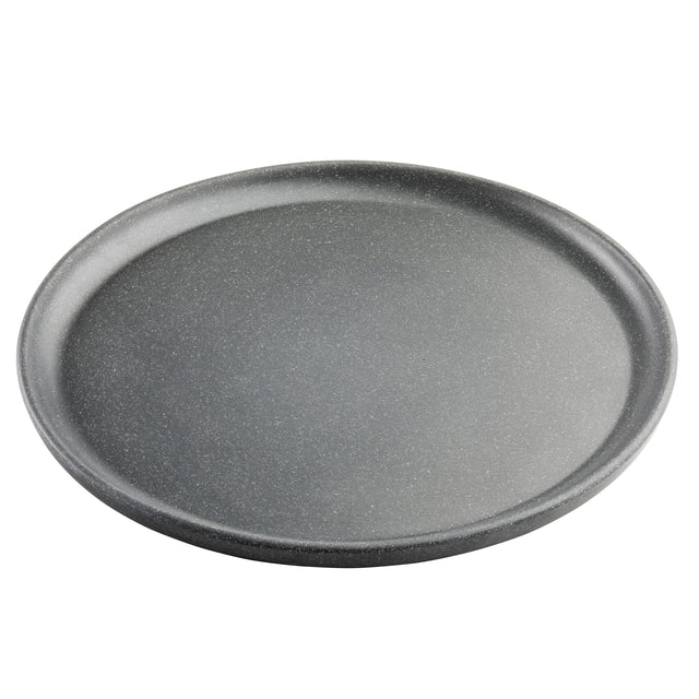 A round, gray, non-stick pizza pan from the Terra Collection is pictured on a white background. Its subtly speckled surface gives a stone-like appearance, resembling a stylish serving plate. The empty pan is viewed from a slight angle.