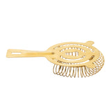 A gold stainless steel cocktail strainer with a flat handle and circular coil spring, perfect for straining ice from mixed drinks. The handle features a rectangular hole near the end. The strainer is displayed against a white background.