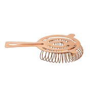 A copper TableCraft cocktail strainer with a flat, oval-shaped handle and a coiled spring around its edge, crafted from stainless steel, is designed for straining ice and fruit pulp from mixed drinks, shown against a white background.