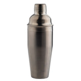 A 24 oz stainless steel cocktail shaker stands upright against a plain white background. The shaker features a smooth, metallic surface with a cap and a slightly wider body that tapers gracefully towards the base.
