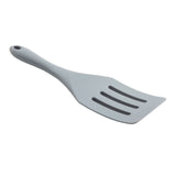 A light gray, plastic slotted spatula with an NSF-certified design features a slightly angled handle and three rectangular slots in the flat blade. The handle has a hole near the end for hanging. The spatula is positioned on a white background.