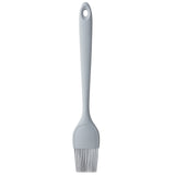 A gray silicone basting brush with a long handle and a hanging hole. The NSF-certified bristles are flexible and evenly spaced, perfect for applying sauces or oils in cooking. The basting brush is shown on a white background.