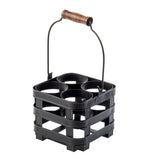 A black plastic drink carrier inspired by the TableCraft Forge Collection, with four circular slots for bottles or cups and a sturdy metal handle topped with a wooden grip. The open, stackable design is ideal as a squeeze bottle caddy or for carrying beverages.