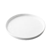 A plain, round, white ceramic plate with a slightly raised edge from the Ridge Collection Serving Plate series, photographed on a white background. The plate is empty and has a smooth, glossy surface.